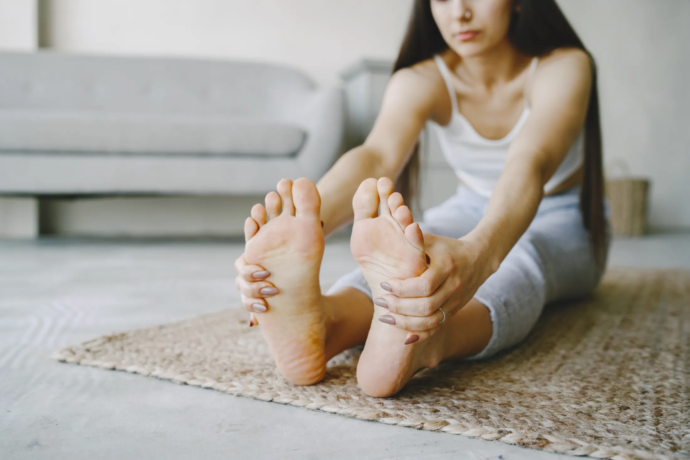 girl-doing-yoga-exercises-home-near-sofa